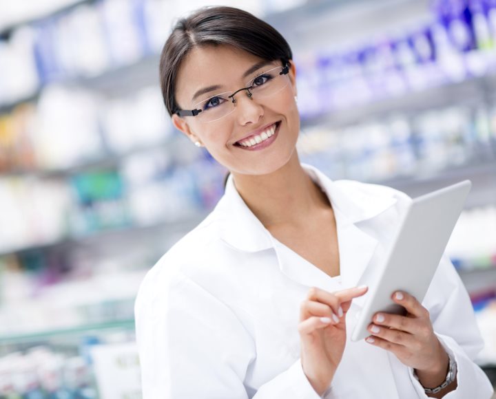 Woman at the drugstore using a digital tablet to take an order